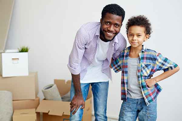 Affectionate man and his son just relocated to new house or flat