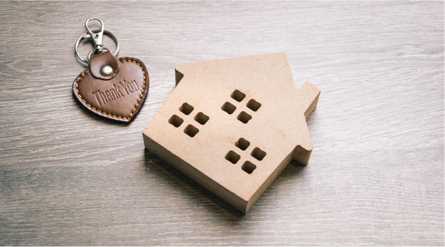 Small cardboard house with heart keychain